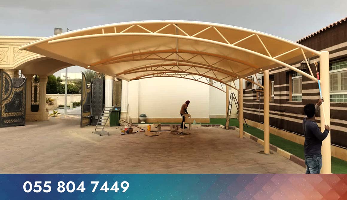 Two of our skilled workers in Dubai are erected and painting car park shades